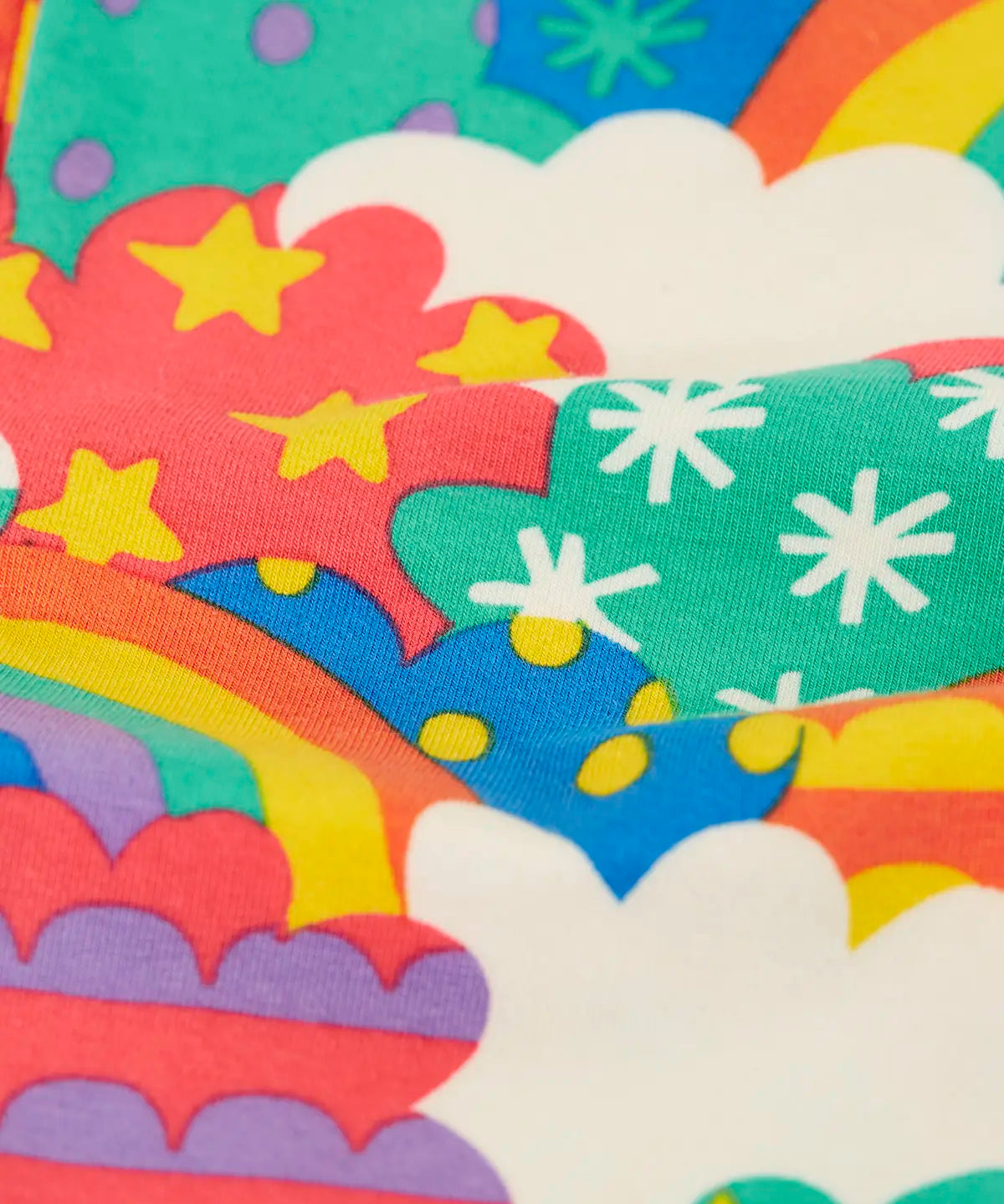 Close up of the soft organic cotton of the Frugi Leona leggings with a colourful fun frenzy print.