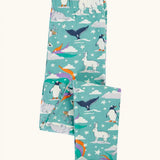 Frugi libby organic cotton leggings in moss green with an polar aurora all over print shown folded.  Blue green background with and all over print featuring polar animals among star and colourful swishes. 
