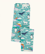 Frugi libby organic cotton leggings in moss green with an polar aurora all over print shown folded.  Blue green background with and all over print featuring polar animals among star and colourful swishes. 