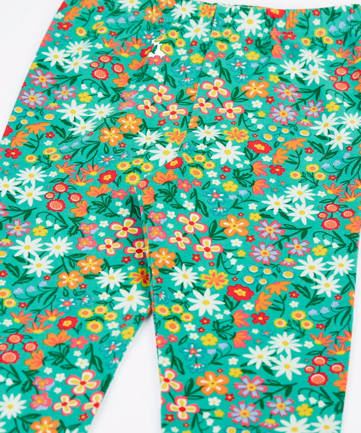 Close up of the Frugi Libby leggings with a wildflower wander all over print 
