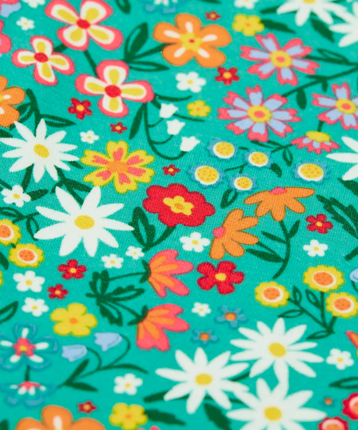 Close up of the floral print on the Frugi Libby leggings with a wildflower wander all over print.