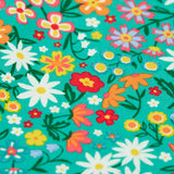 Close up of the floral print on the Frugi Libby leggings with a wildflower wander all over print.