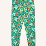 Frugi Libby organic cotton leggings with a wildflower wander all over print on a green background. 