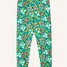 Frugi Libby organic cotton leggings with a wildflower wander all over print on a green background. 