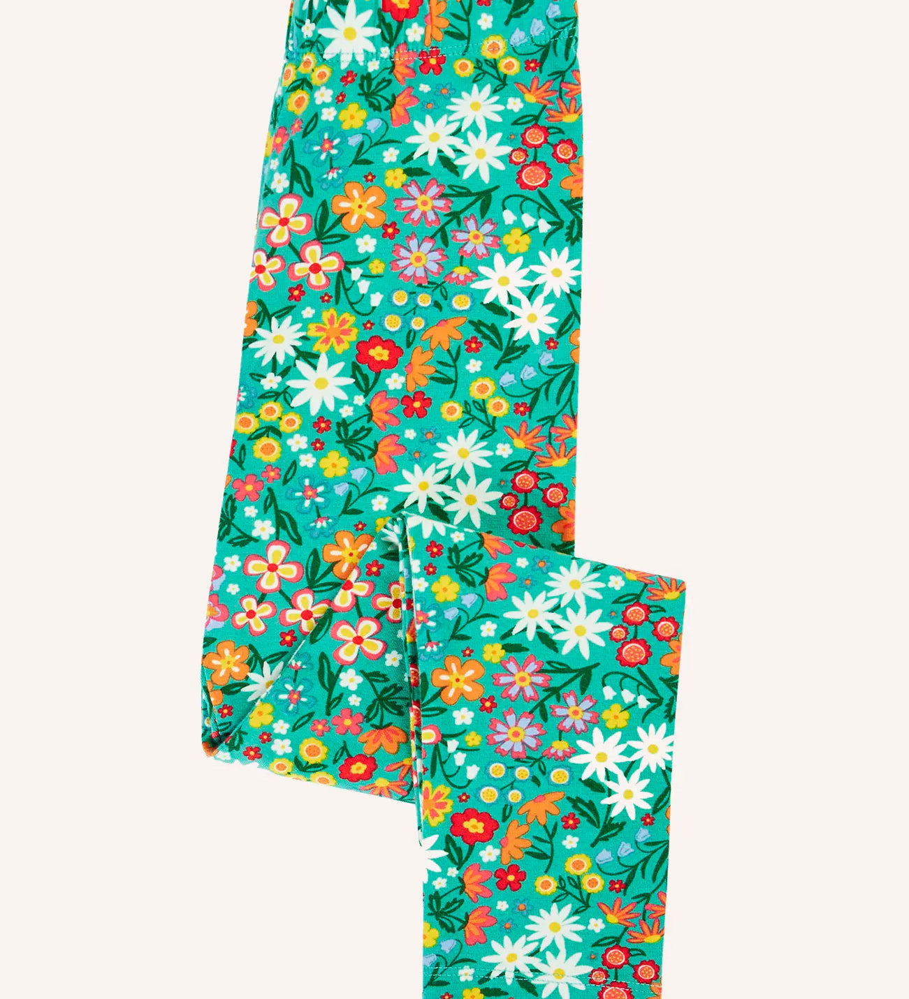 Frugi Libby leggings with a wildflower wander all over print on a green background shown folded. 