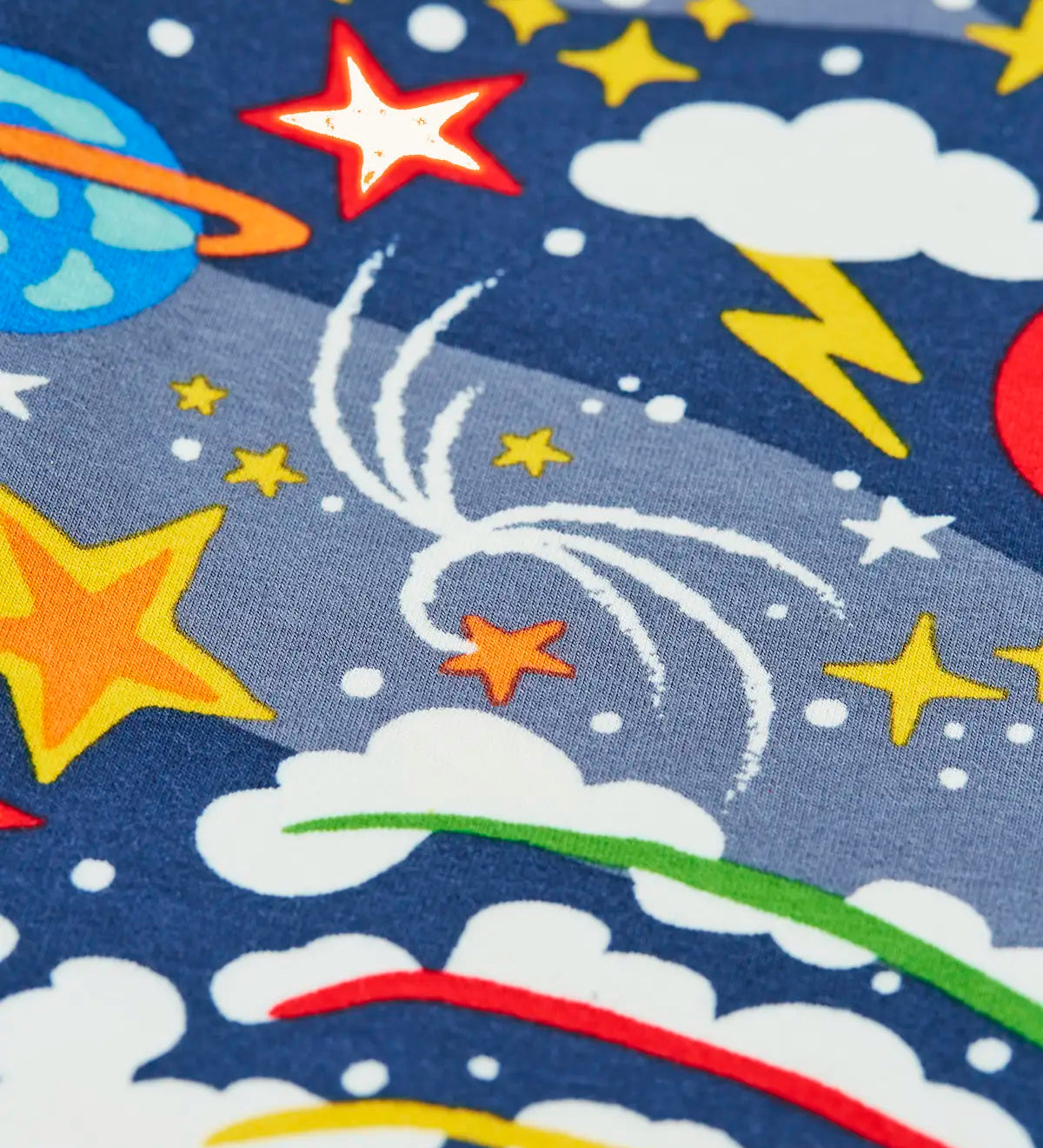 Close up of the print on the Frugi libby navy organic cotton leggings with explore the stars, space themed print. 