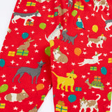 Close up of the Frugi organic cotton libby leggings with a perfect paw-ty party print showing the elasticated waist. Red background with all over print featuring pets with party hats surrounded by gifts and baloons.