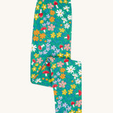 Frugi Libby leggings with a wild woods, botanical design on a green background. 