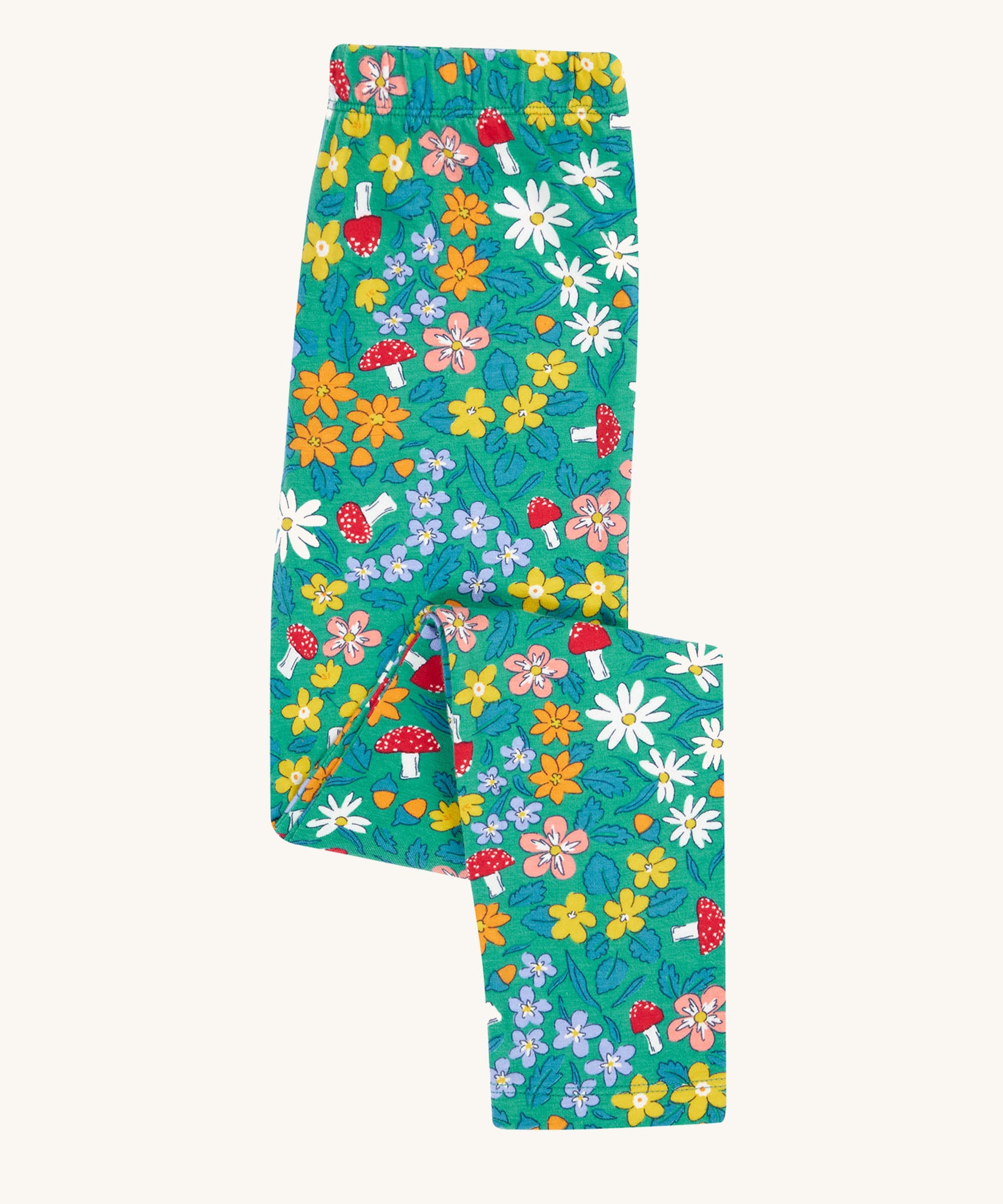Frugi Libby leggings with a wild woods, botanical design on a green background. 