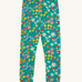 Frugi Libby leggings with a wild woods, botanical design on a green background. 