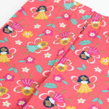 Close up showing the elasticated waistband on the Frugi organic cotton libby leggings with a fairy flutters print. Pink background with all over print featuring fairies and flowers.