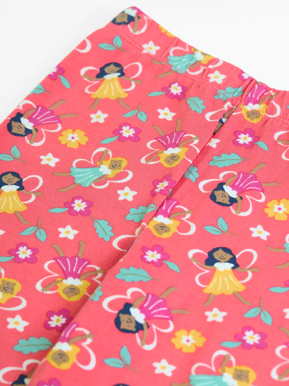 Close up showing the elasticated waistband on the Frugi organic cotton libby leggings with a fairy flutters print. Pink background with all over print featuring fairies and flowers.