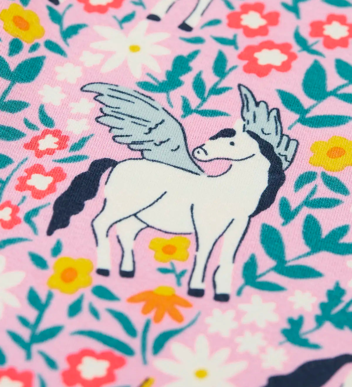 Close up of one of the Pegasus on the Frugi organic cotton libby leggings with a floral flight print. Pink background with all over print featuring flowers, foliage and Pegasuses.