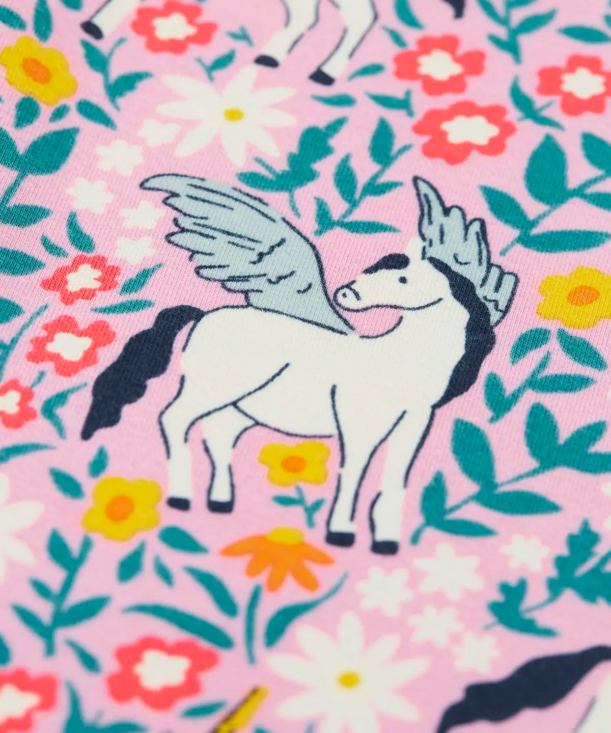Close up of one of the Pegasus on the Frugi organic cotton libby leggings with a floral flight print. Pink background with all over print featuring flowers, foliage and Pegasuses.