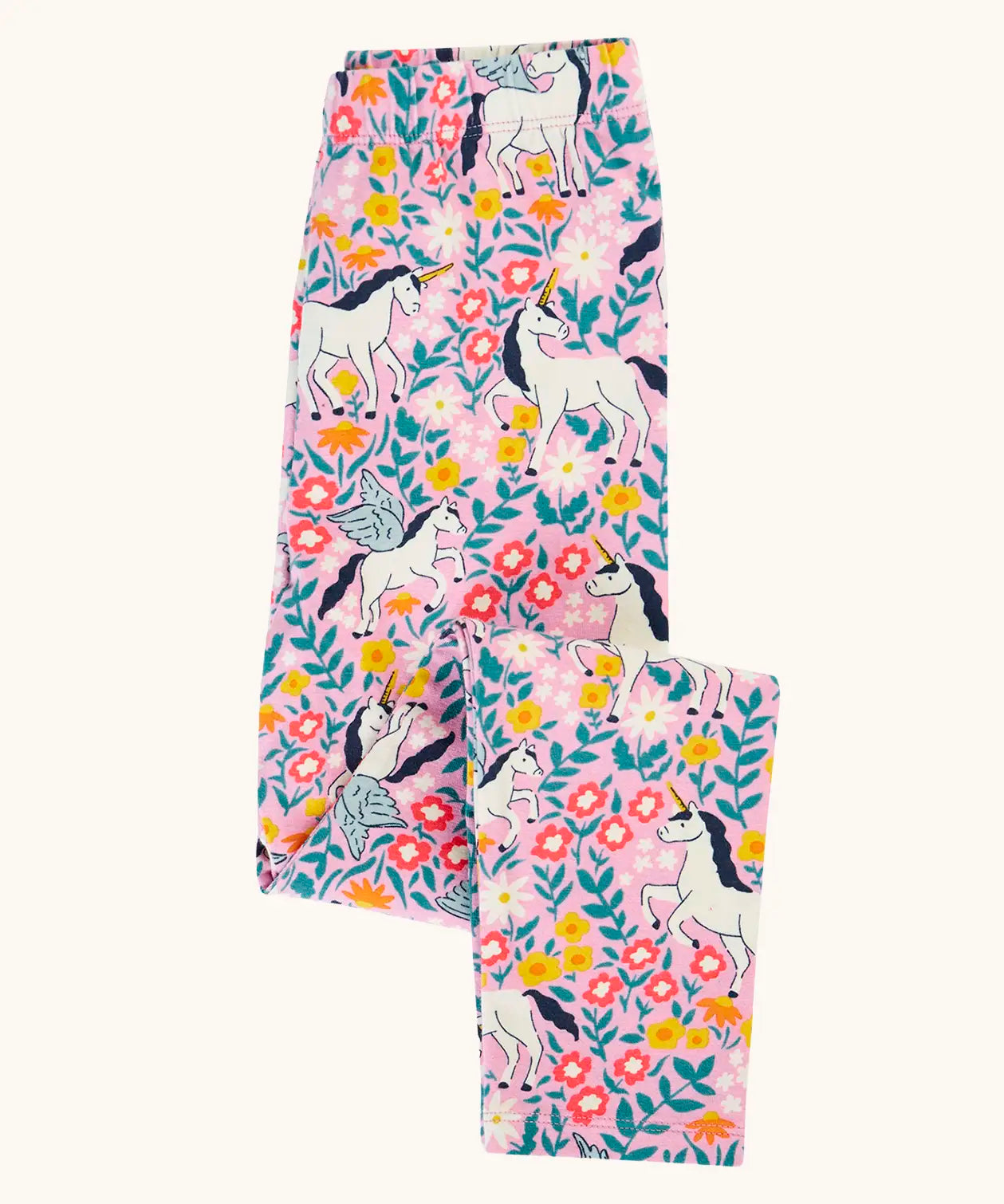 Frugi organic cotton libby leggings with a floral flight print shown folded. Pink background with all over print featuring flowers, foliage and Pegasus.