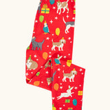 Frugi organic cotton libby leggings with a perfect paw-ty party print shown folded. Red background with all over print featuring pets with party hats surrounded by gifts and baloons.