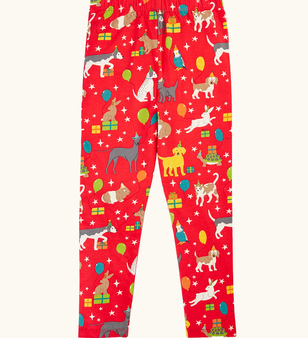 Frugi organic cotton libby leggings with a perfect paw-ty party print. Red background with all over print featuring pets with party hats surrounded by gifts and baloons.