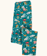 Frugi organic cotton libby leggings with a winter drives print shown folded. Teal background with all over print featuring reindeer, houses, trees and vehicles.
