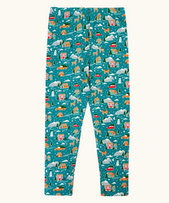 Frugi organic cotton libby leggings with a winter drives print. Teal background with all over print featuring reindeer, houses, trees and vehicles.