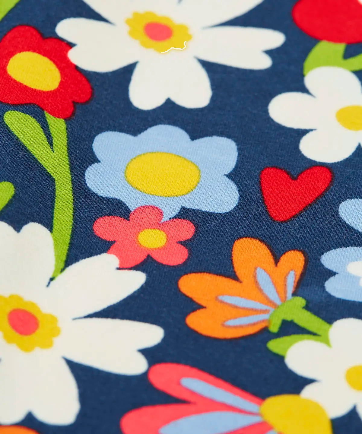Close up of the print on the Frugi libby beautiful bunch printed organic cotton leggings. Navy coloured background with all over flower print.