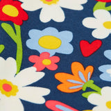 Close up of the print on the Frugi libby beautiful bunch printed organic cotton leggings. Navy coloured background with all over flower print.