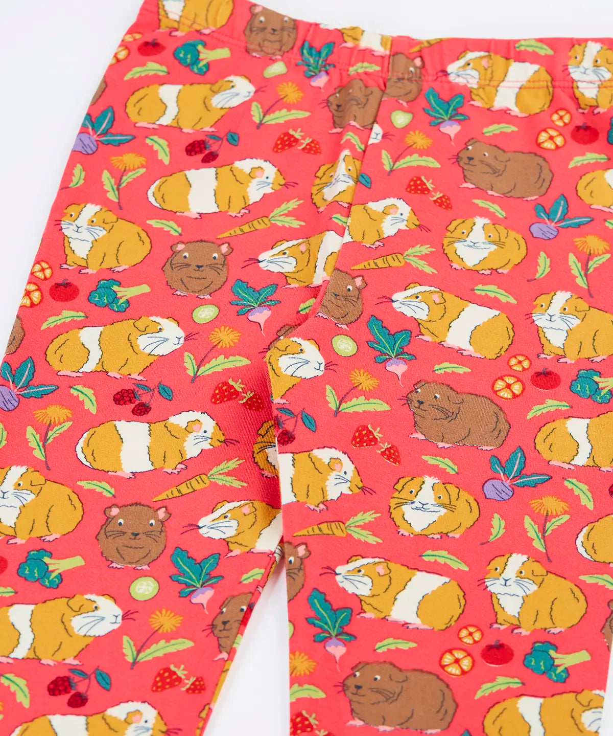 Close up of the Frugi libby pink organic cotton  leggings with an all over guinea pig muddle print. 