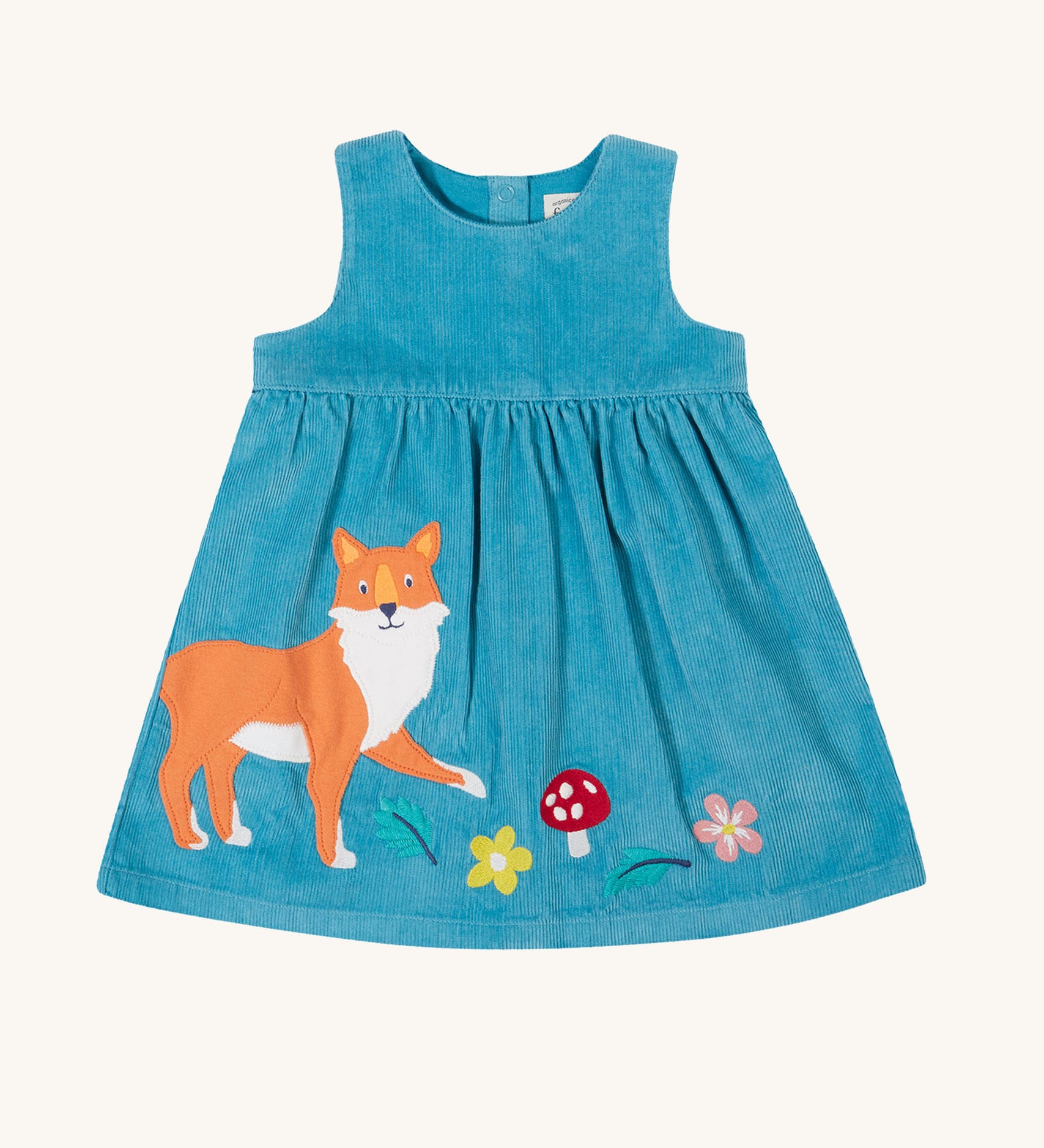 The Frugi Lily blue organic cotton cord children's dress with fox, mushroom and flowers appliques on the front.