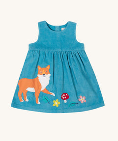 The Frugi Lily blue organic cotton cord children's dress with fox, mushroom and flowers appliques on the front.