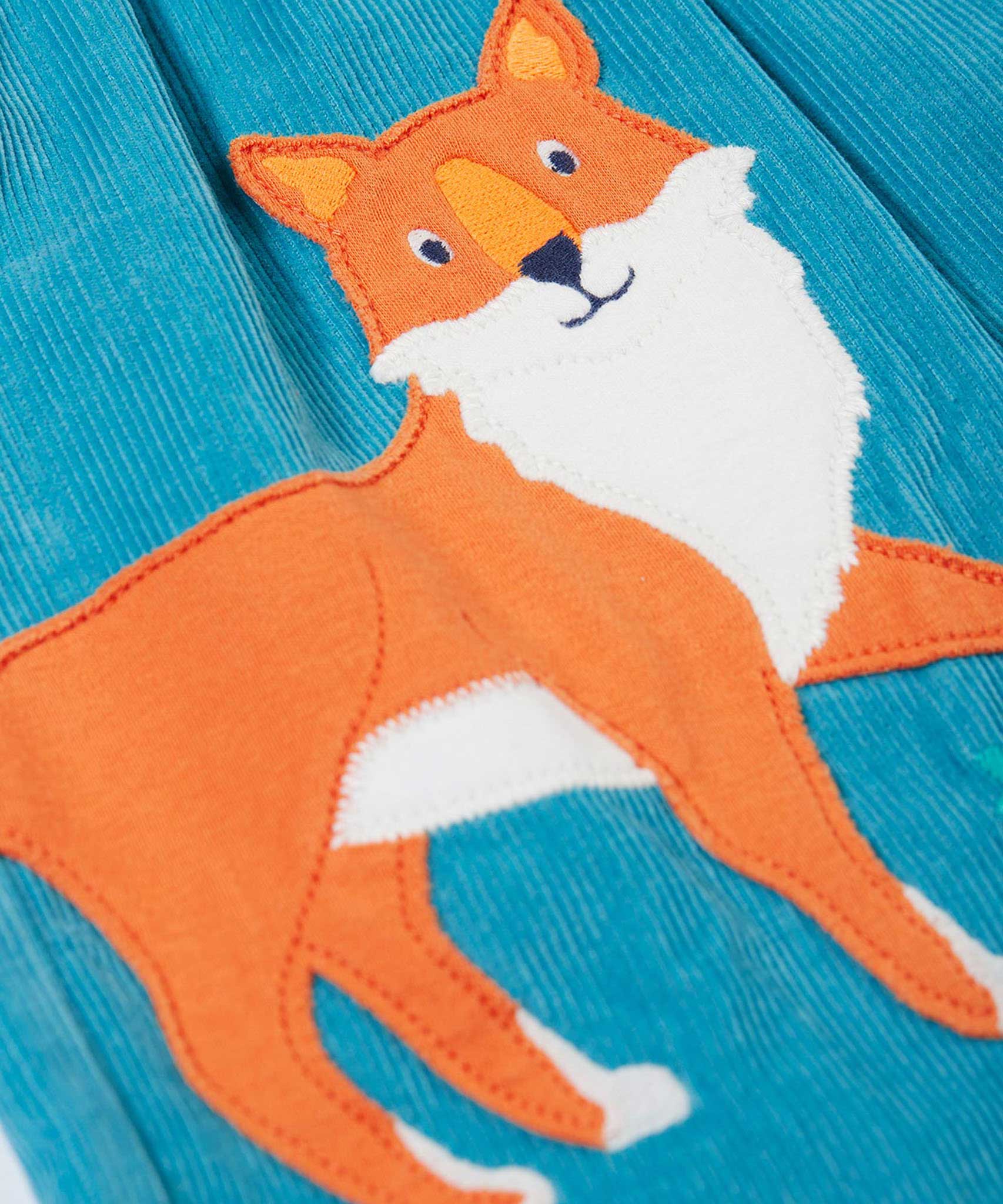 A close up of the fox applique on the Frugi Lily blue organic cotton cord children's dress.