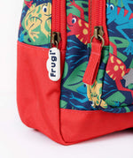 A close up of the bottom of the Frugi little adventures be hoppy backpack showing the zip detail and red trim. 