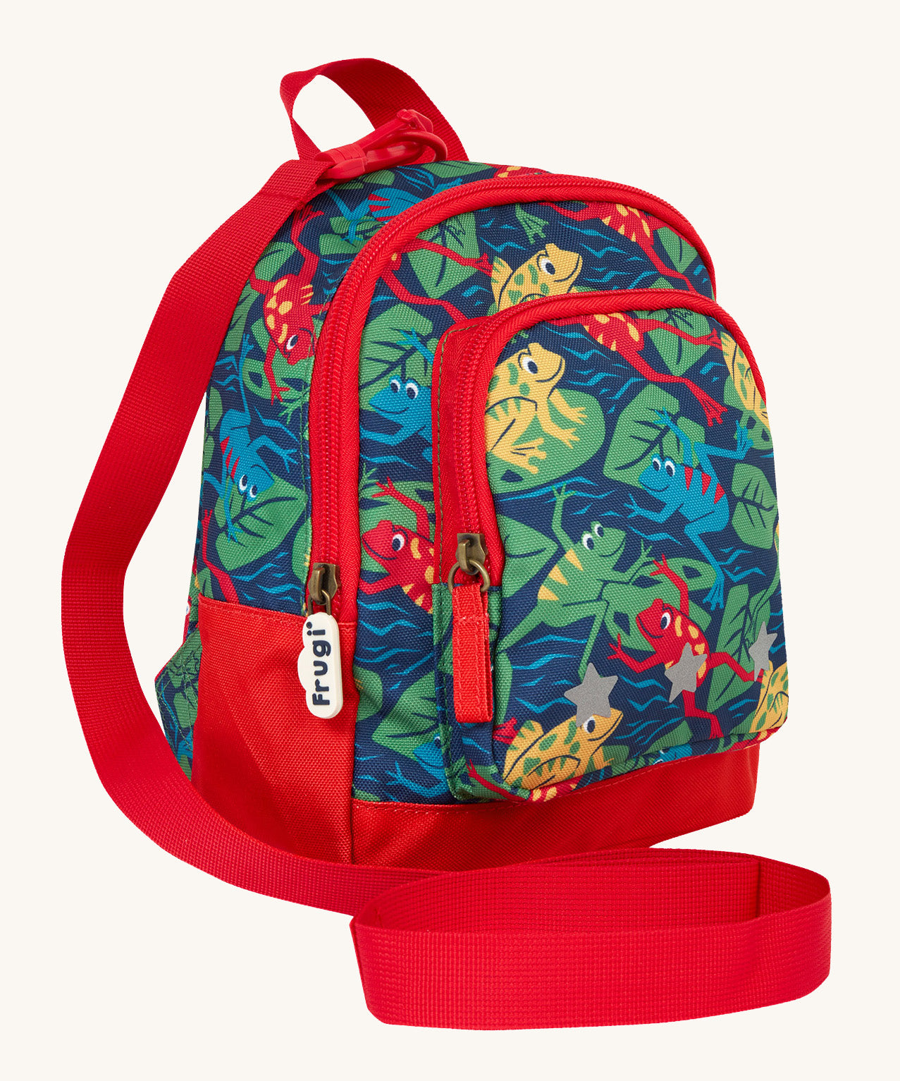 Side view of the Frugi little adventures be hoppy backpack showing the zip detail and handy red rein that's clipped to the top of the bag.