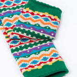 A close up of the green cuff details on the Frugi organic cotton little knitted leggings with a bear fair isle design. 