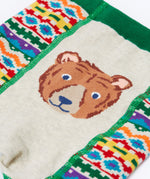 A close up of the brown bear on the bottom of the Frugi organic cotton little knitted fair isle leggings.