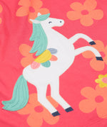 A close up of the Frugi little Lola floral fun / horse dress. Showing the white horse appliqué with light green hair next to appliqué flowers surrounded with light orange printed flowers on a pink organic cotton fabric