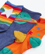 Close up of the Frugi little roly bamboo socks in a 3 pack with spac edesign. Rainbow stripe with white star pair, navy with planet pair and an orange with rainbow stars pair.
