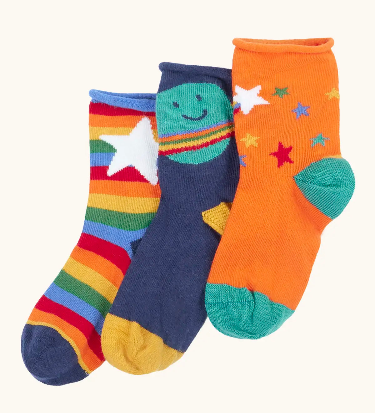 Frugi little roly bamboo socks in a 3 pack with space edesign. Rainbow stripe with white star pair, navy with planet pair and an orange with rainbow stars pair.