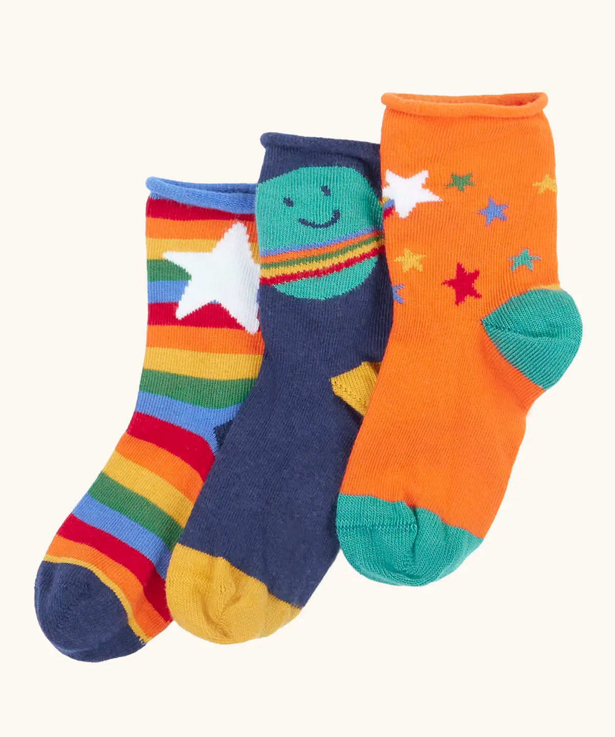 Frugi little roly bamboo socks in a 3 pack with space edesign. Rainbow stripe with white star pair, navy with planet pair and an orange with rainbow stars pair.