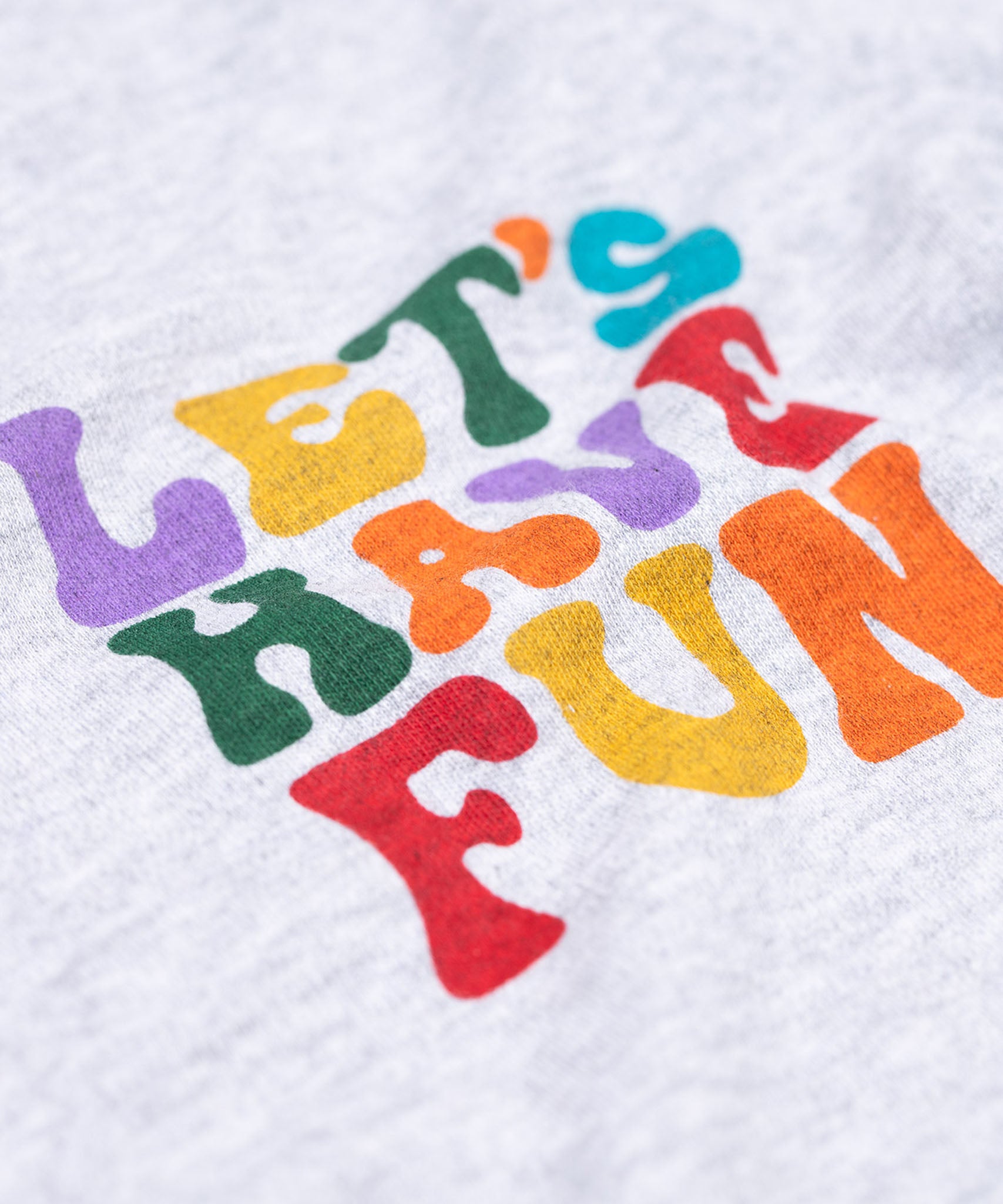 A close up of the text on the front of the Frugi Adventure Organic Cotton Printed Kids' grey Top.