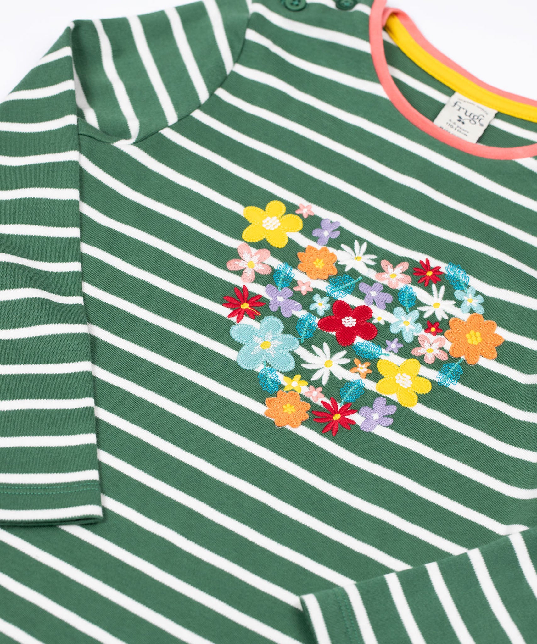 A close up of the front of the Frugi Louise embroidered heart holly green breton stripe long sleeved top.  