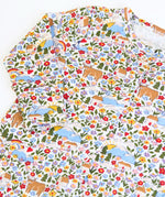 Close up of the print on the Frugi lovely babygrow with an all over highland fields print. 