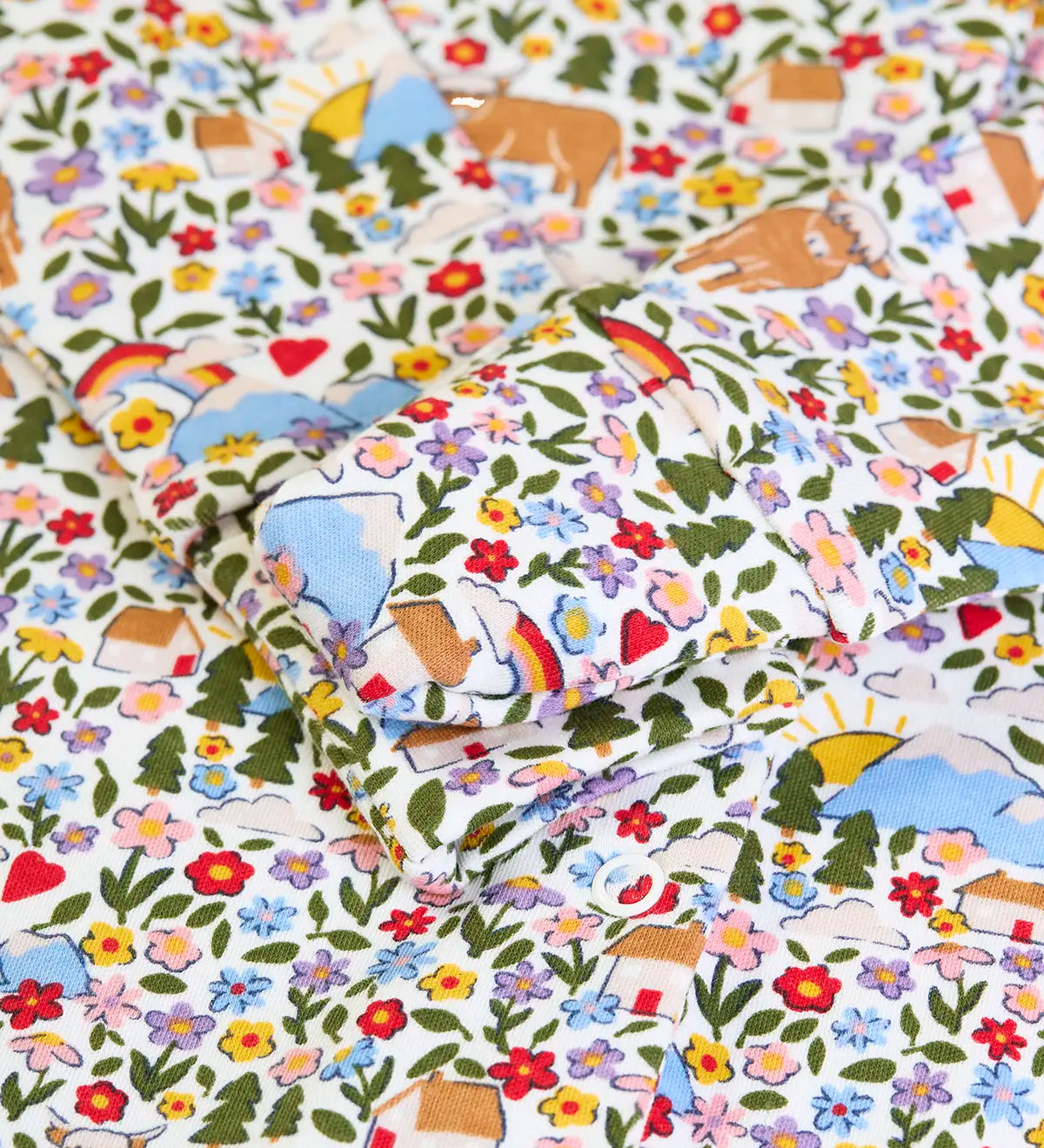 Close up of the fold over buuilt in scratch mitts on the Frugi lovely babygrow with an all over highland fields print. 