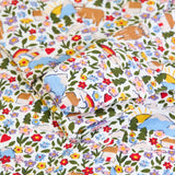 Close up of the fold over buuilt in scratch mitts on the Frugi lovely babygrow with an all over highland fields print. 