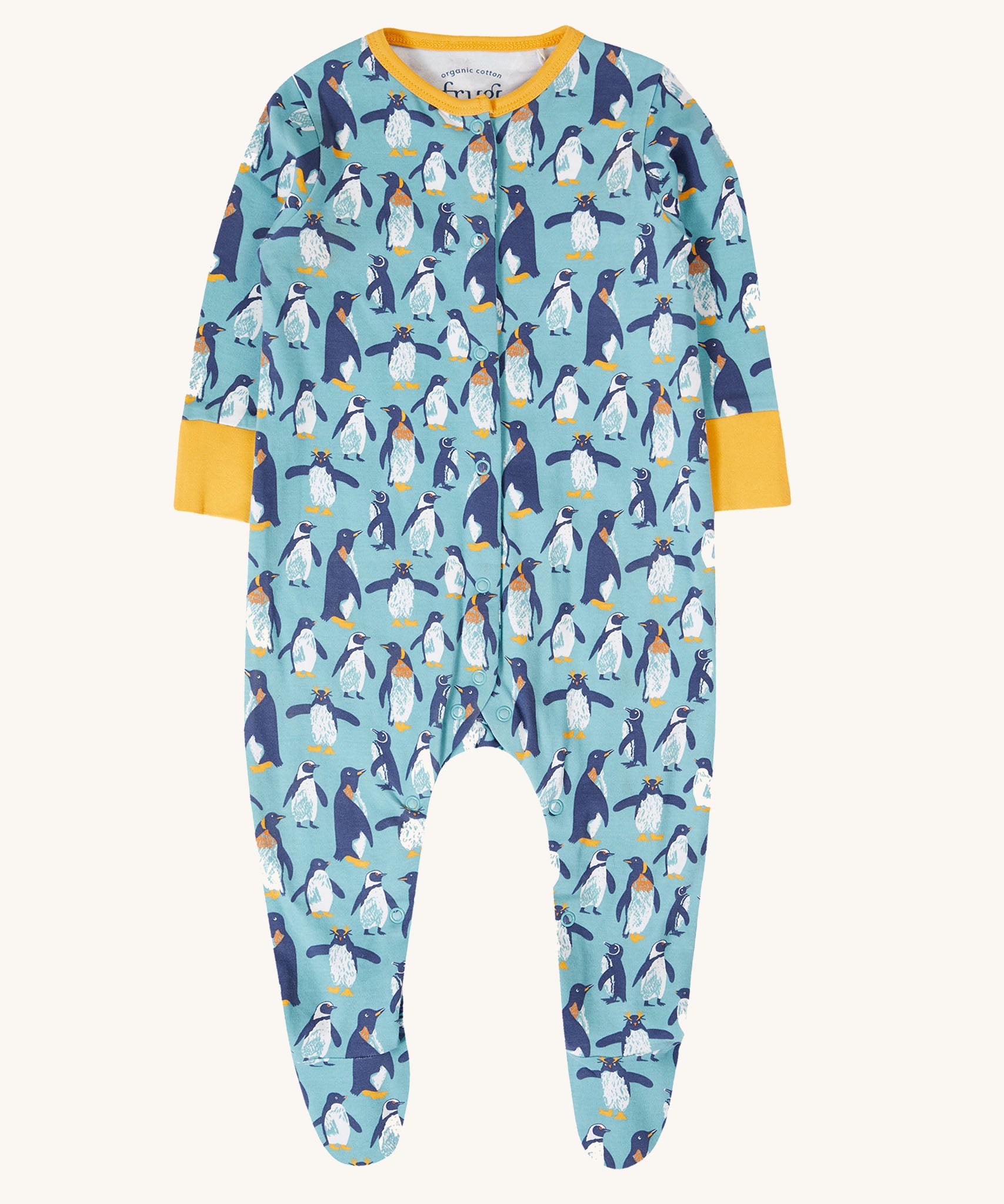 The Frugi Lovely babygrow in a blue penguin waddle design. A hand illustrated style, all over penguin print on a blue background with yellow gold coloured fold-able cuffs on the arms and yellow gold coloured binding on the neck. 