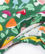 A close up of the popper closure on the Frugi Lovely Babygrow with a fun guys design. The green coloured organic cotton babygrow has multi coloured mushrooms with happy faces.