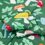 A close up of the fold-able sleeves on the Frugi Lovely Babygrow with a fun guys design. The green coloured organic cotton babygrow has multi coloured mushrooms with happy faces.