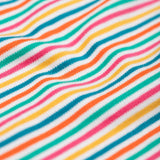 A close up of the material of the Frugi Lucia Multi Stripe Long Sleeved Organic Cotton Top. A multi-coloured, white, blue, yellow, pink and green thin striped design made with organic cotton.