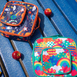 Frugi fun frenzy pack a lunch bag. A multicoloured abstract cloud design. Main and a small front compartment and a carry handle. The explore the stars bag can be seen in the background.
