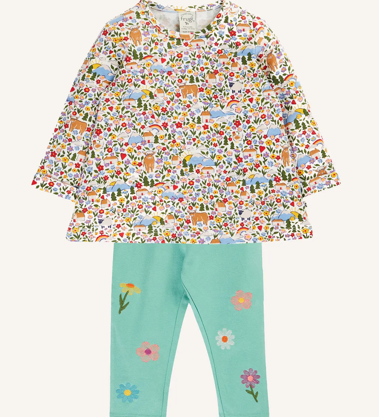 Frugi mabel outfit with moss green trousers with flowers and a highland fields print long sleeved top.