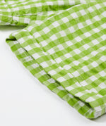 Close up of the Frugi kids macaw gingham Giles short showing the turned up leg detail on green gingham organic cotton fabric