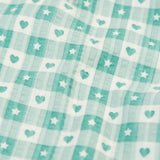 Close up of the light green and white check style hearts and stars pattern on the Frugi magic nights organic cotton hayley traditional pyjamas.